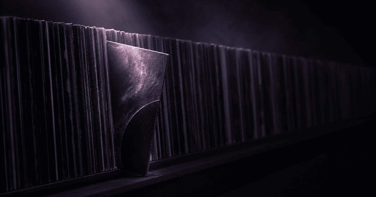 Rack of vinyl records in darkness with one record pulled forward into light